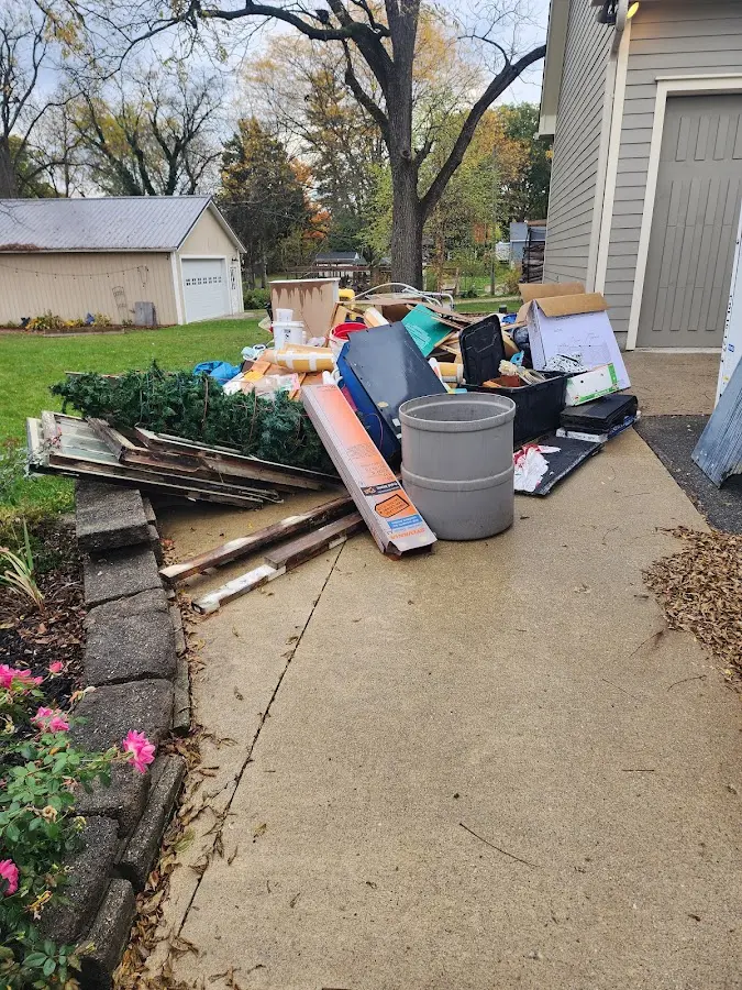 Dumpster being loaded with debris for Roofing Dumpster Rental in Peachtree Corners